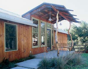 The front entry's unique support beams and bench were built from a centuries-old oak tree that fell on the property before construction began.
